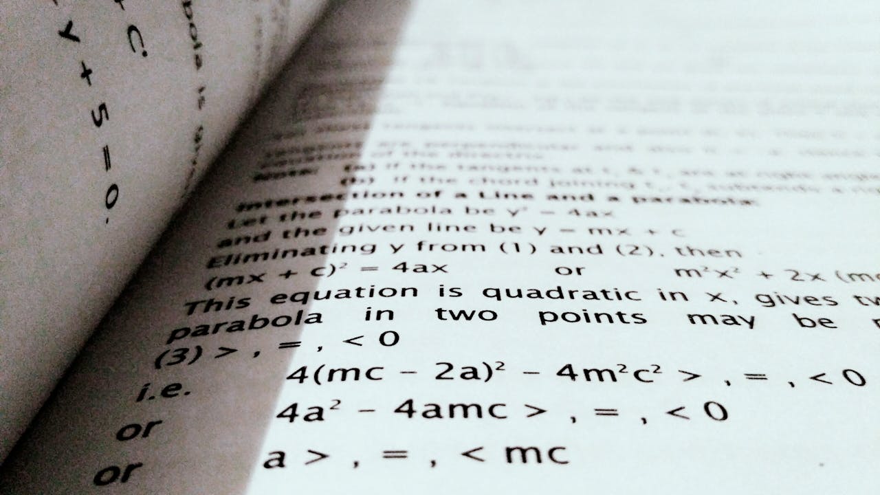 A close-up shot of mathematical equations on a book page, perfect for education and learning concepts.
