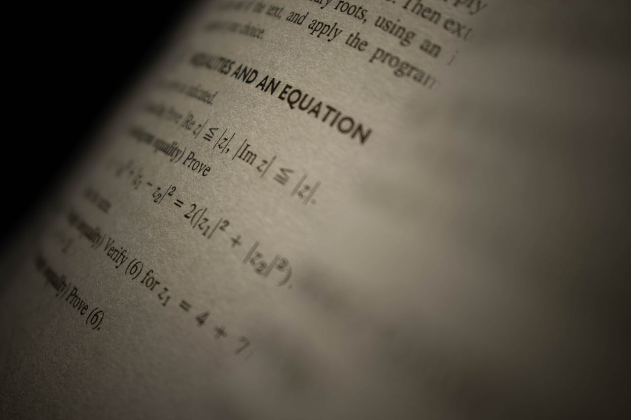 Selective focus on a mathematics textbook page with complex equations and text.